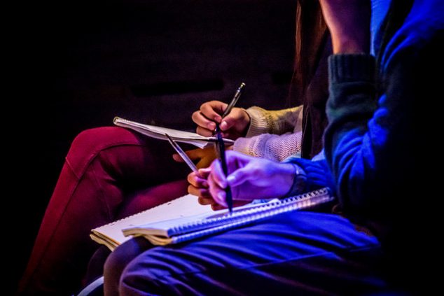 new writing series audience members taking notes